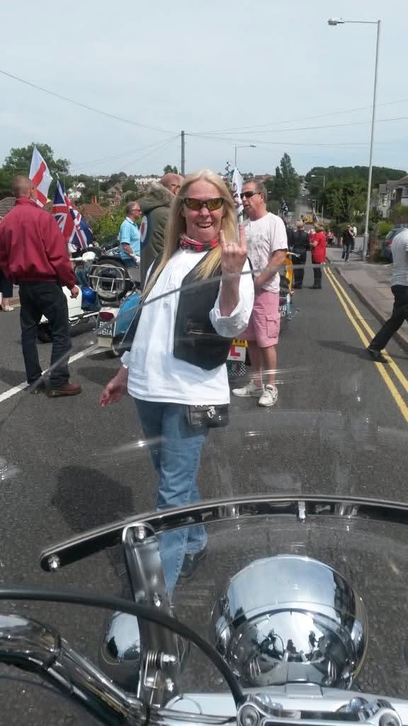 May be an image of motorcycle, scooter, rearview mirror and road